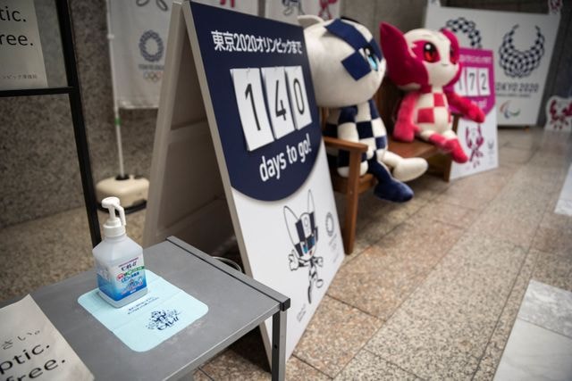 A bottle of hand gel is placed next to Tokyo 2020 Olympic Games mascots