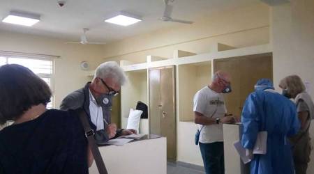 Italian nationals being quarantined to guard against coronavirus fill up forms at ITBP's quarantine facility in Chhawla near New Delhi, India. (Indo Tibetan Border Police Force via AP). 