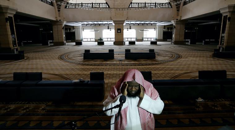  A cleric calls for the prayer at an empty Al-Rajhi Mosque, as Friday prayers were suspended following the spread of the coronavirus disease (COVID-19), in Riyadh