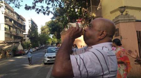 A man blows a conch shells at 5 pm in Mumbai. (Express photo  by Ganesh Shirsekar)