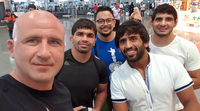 Foreign Wrestling Coaches Torn Between Family Responsibility Due