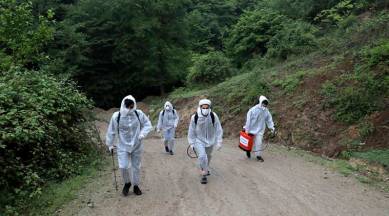 Volunteers wearing protective clothing, take part in disinfecting a village, in the outskirts of the city of Ghaemshahr, in north of Iran, Wednesday, April 29, 2020. (AP Photo/Ebrahim Noroozi)