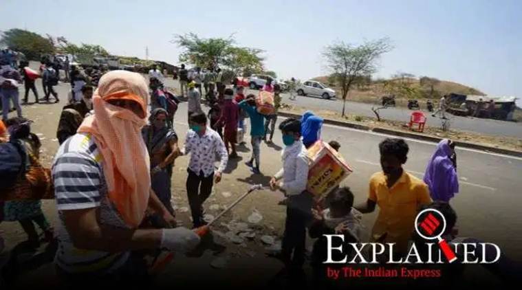 india coronavirus lockup, migrants sprayed with chemicals, migrant workers sprayed with disinfectant, spraying with coronavirus disinfectant, enclosure covid-19, migrants from india, migrants sprayed with disinfectants, naked migrant workers, Indian Express