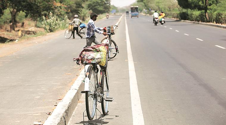coronavirus, coronavirus news, covid 19 tracker, covid 19 india tracker, UP migrants in Surat, Surat migrants on cycle, migrant exodus, Indian express