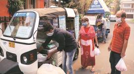 People buy goods from the mobile stalls at Salt Lake in Kolkata on Thursday. (Express photo by Partha Paul)