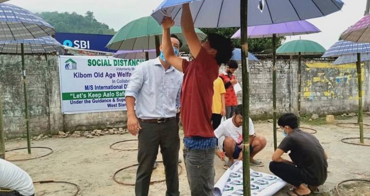 Arunachal Pradesh, Aalo, Social Distancing, Umbrella, Dr Jumge Padu, COVID-19, Coronavirus, india Lockdown, arunachal pradesh news, indian express