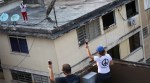 Venezuelans pass wine across rooftops to celebrate happy hour in quarantine