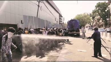 migrant workers, spraying disinfectant, coronavirus crisis, india lockdown, delhi news, Indian express news