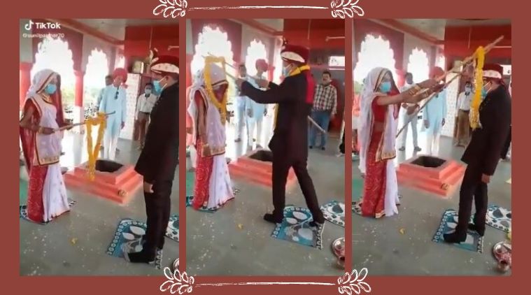 Watch: Couple exchange garlands using sticks during wedding, video goes  viral | Trending News,The Indian Express