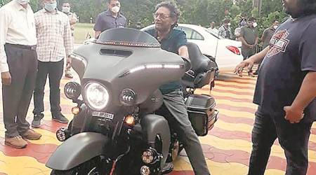 Chief Justice of India S A Bobde checks out a guest’s motorbike at a ceremony in Raj Bhavan in Nagpur on Sunday. (Express)