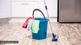Plastic bucket with cleaning supplies in home. cleaning the kitchen domestic help, coronavirus