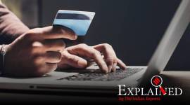 Man shopping online using laptop computer and credit card digital payments, India digital payments, India online bank transfer, India digital banking, Indian Express