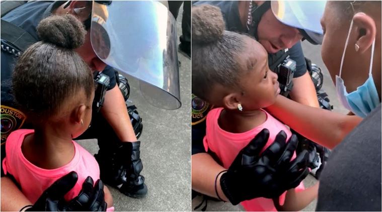 police officer comforts girl protest, black girl comforted by cops, houston police comfort girl protest rally, black lives matter, blm protest, george floyd, viral videos, indian express