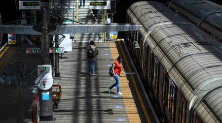 A commuter boards a London Undergound train on a platform at Earls Court station in London, U.K., on Thursday, May 21, 2020. The government in London is trying to reboot the economy while also extending a stay-at-home pay program.
