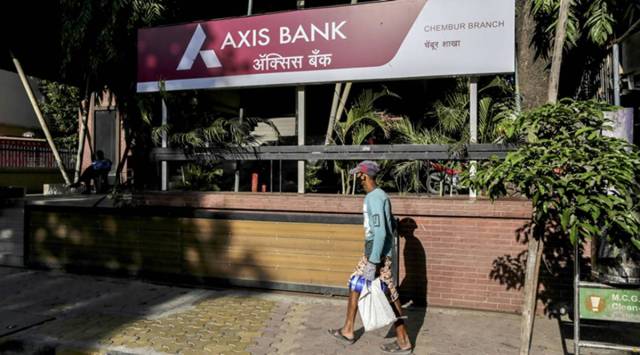 A pedestrian wearing a protective mask walks past an Axis Bank Ltd. branch on a near-empty street in Mumbai, India, on Monday, May 4, 2020. (Bloomberg/File photo)