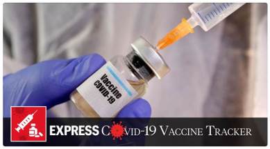 A woman holds a small bottle labeled with a "Vaccine COVID-19" sticker and a medical syringe in this illustration taken April 10, 2020. REUTERS/Dado Ruvic/File Photo