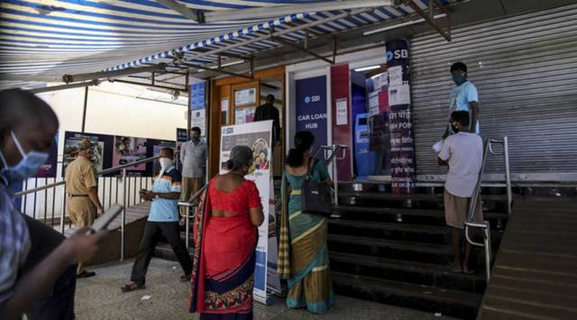 Customers wait in line at a State Bank of India (SBI) branch in Mumbai, India, on Monday, May 4, 2020. (Photographer: Dhiraj Singh/Bloomberg)