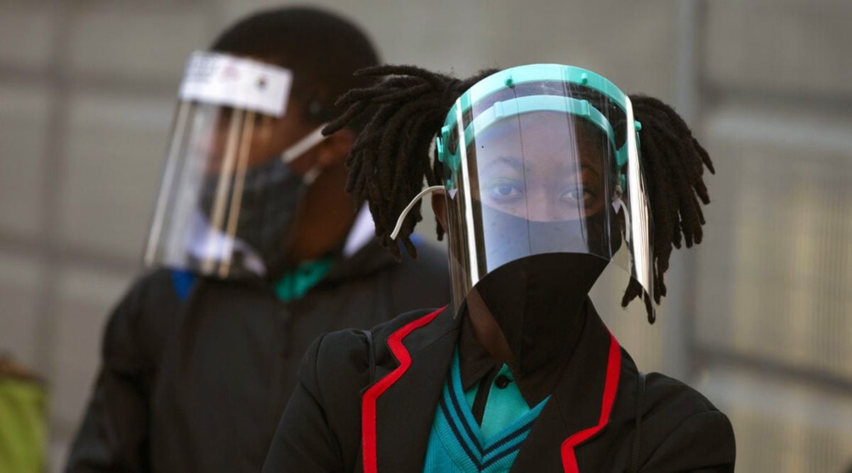 School children wear masks and protective gear in Johannesburg, South Africa. (AP Photo/Denis Farrel)