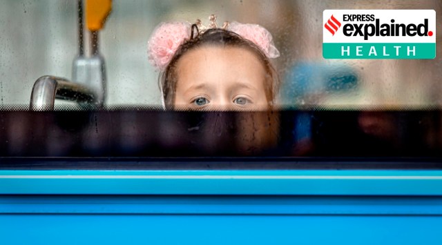 A girl peers from behind a window in Bucharest, Romania, Wednesday, August 19, 2020. (AP Photo: Andreea Alexandru, File)