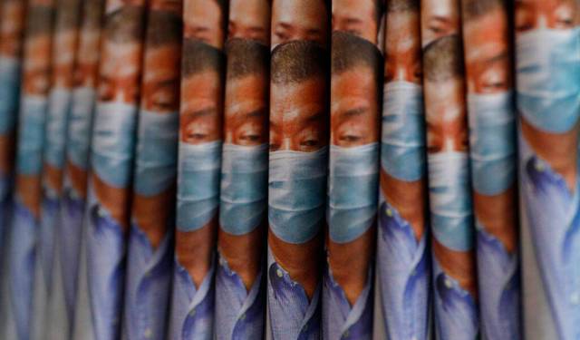 Copies of Apple Daily newspaper with front pages featuring Hong Kong media tycoon Jimmy Lai, are displayed for sale at a newsstand in Hong Kong, Tuesday, Aug. 11, 2020. Hong Kong police have arrested Lai and raided the publisher's headquarters, broadening their enforcement of a new security law and raising fears about press freedom in the semi-autonomous Chinese city. (AP Photo/Kin Cheung)