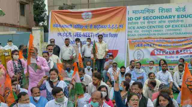 Uttarakhand Congress President Pritam Singh along with party workers stages a sit-in protest outside CBSE office demanding cancellation of NEET and JEE examinations in the view of coronavirus pandemic, in Dehradun, Friday. In Delhi, several Congressmen were detained by the police near the Shastri Bhawan and taken to the Mandir Marg police station, Delhi Congress president Anil Kumar said. (PTI Photo)