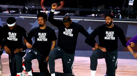 Los Angeles Lakers' LeBron James  kneels during the national anthem prior to the NBA basketball game against the Oklahoma City Thunder Wednesday, Aug. 5, 2020, in Lake Buena Vista, Fla. (Kevin C. Cox/Pool Photo via AP)