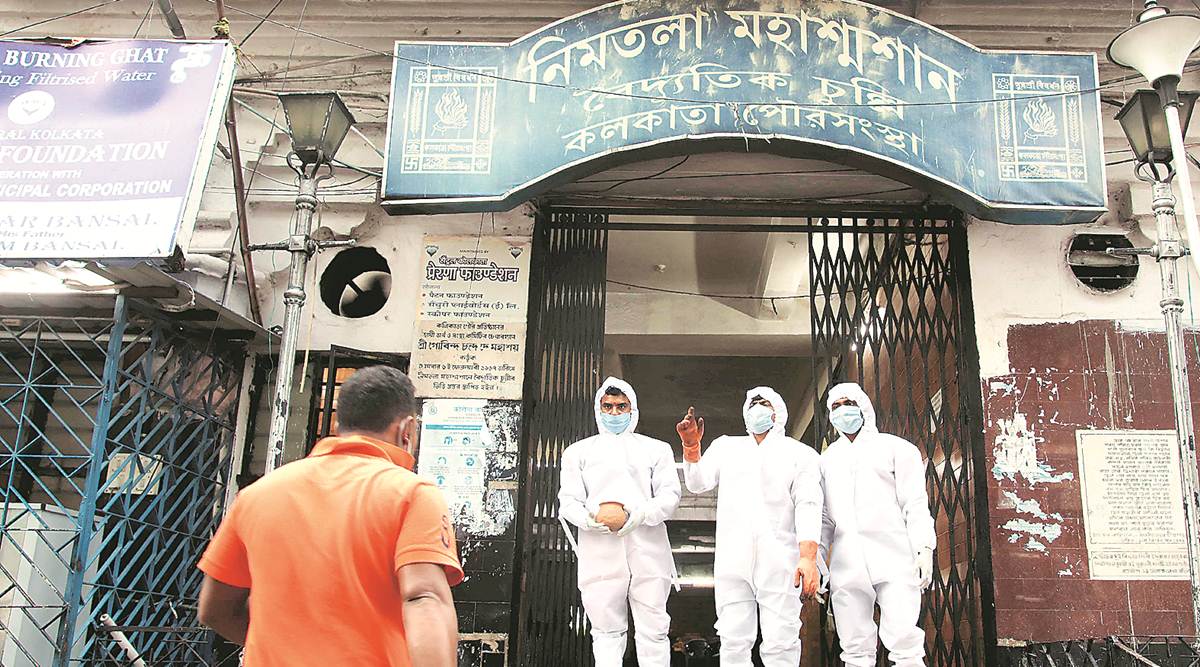 Staff at a crematorium in Kolkata. (Express photo by Partha Paul)