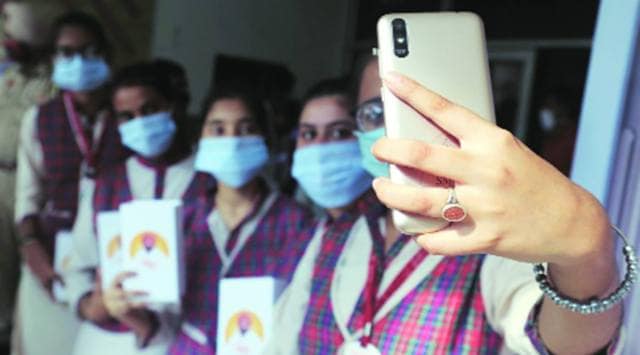 Students click a selfie with a smart phone received from the state government in Ludhiana Wednesday. Gurmeet Singh