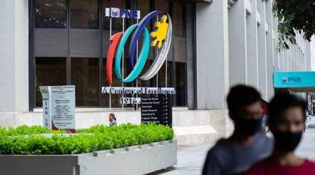 Pedestrians wearing protective mask walk near the Philippine National Bank (PNB) Center in Makati City, Metro Manila, the Philippines, on Monday, July 27, 2020. President Rodrigo Duterte pushed for corporate tax cuts and targeted support for pandemic-hit industries as part of a recovery plan, and told lawmakers he'd asked Chinese President Xi Jinping to help the Philippines get priority access to a Covid-19 vaccine. Photographer: Geric Cruz/Bloomberg