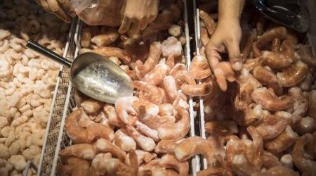 Customers shop for frozen South American shrimp inside a Vanguard hypermarket, operated by China Resources Enterprise Ltd., in Shanghai, China, (Photographer: Qilai Shen/Bloomberg)