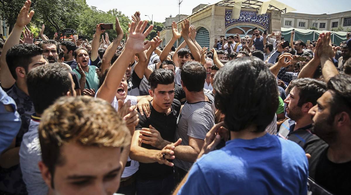  In this June 25, 2018 file photo, a group of protesters chant slogans after Iran broadcast the televised confession of the wrestler facing the death penalty. (Iranian Labor News Agency via AP, File)