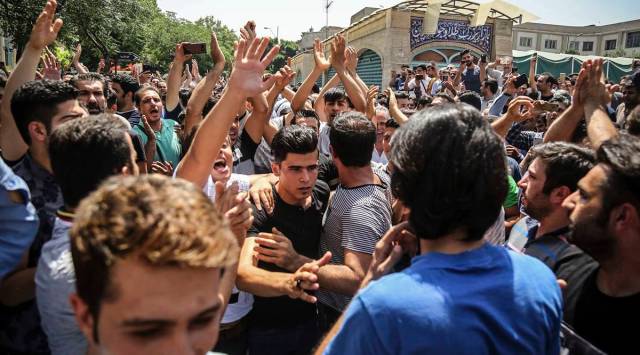  In this June 25, 2018 file photo, a group of protesters chant slogans after Iran broadcast the televised confession of the wrestler facing the death penalty. (Iranian Labor News Agency via AP, File)