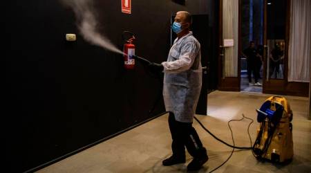 A health security operator sanitizes the premises of the Casino Palace, one of the venues of the 77th edition of the Venice Film Festival at the Venice Lido, Italy (AP)