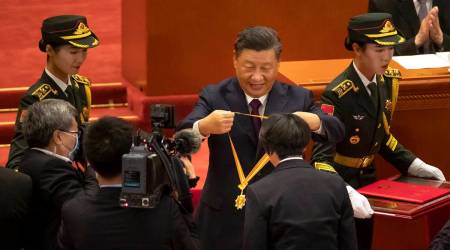 Chinese President Xi Jinping, rear center, presents a medal to an honoree at an event to honor some of those involved in China's fight against COVID-19 at the Great Hall of the People in Beijing (AP)