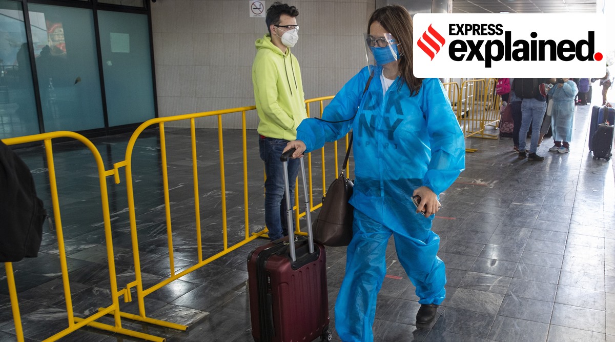 A passenger wearing a protective suit arrives for a flight at La Aurora International Airport in Guatemala City (AP)
