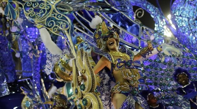 Performer from Beija Flor samba school parades on a float during the Carnival celebrations at the Sambadrome in Rio de Janeiro, Brazil, 2016. (AP Photo/Leo Correa)