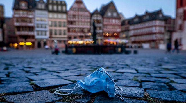 A face mask left in Roemerberg square, that is usually crowded by tourists, in Frankfurt, Germany, Thursday, Sept. 17, 2020. (AP Photo/Michael Probst)
