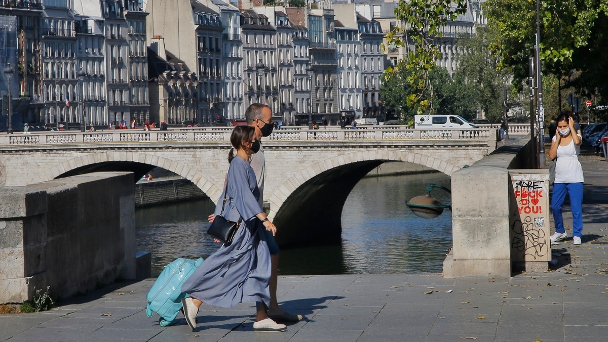 People wearing protective face masks as precaution against the conoravirus walk along the Seine river in Paris, Wednesday, Sept. 9, 2020. (AP Photo)