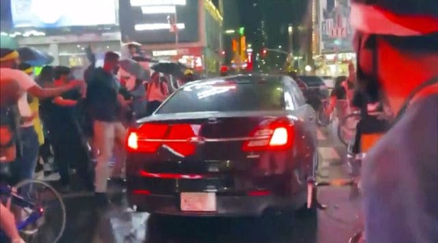 In this frame grab from a video by @datainput from the New York City Police Department Twitter account, a car moves through protesters, in New York's Times Square, Thursday, Sept, 3, 2020. (New York City Police Dept. via AP)