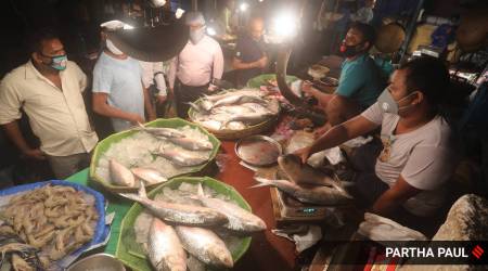 Customers buy hilsa at Maniktala market in Kolkata on Tuesday.  Partha Paul