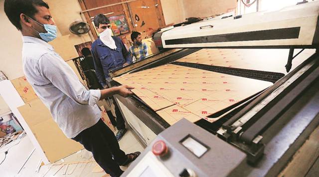 A workshop in a lane cuts glass to stand between Delhi power corridors, virus
