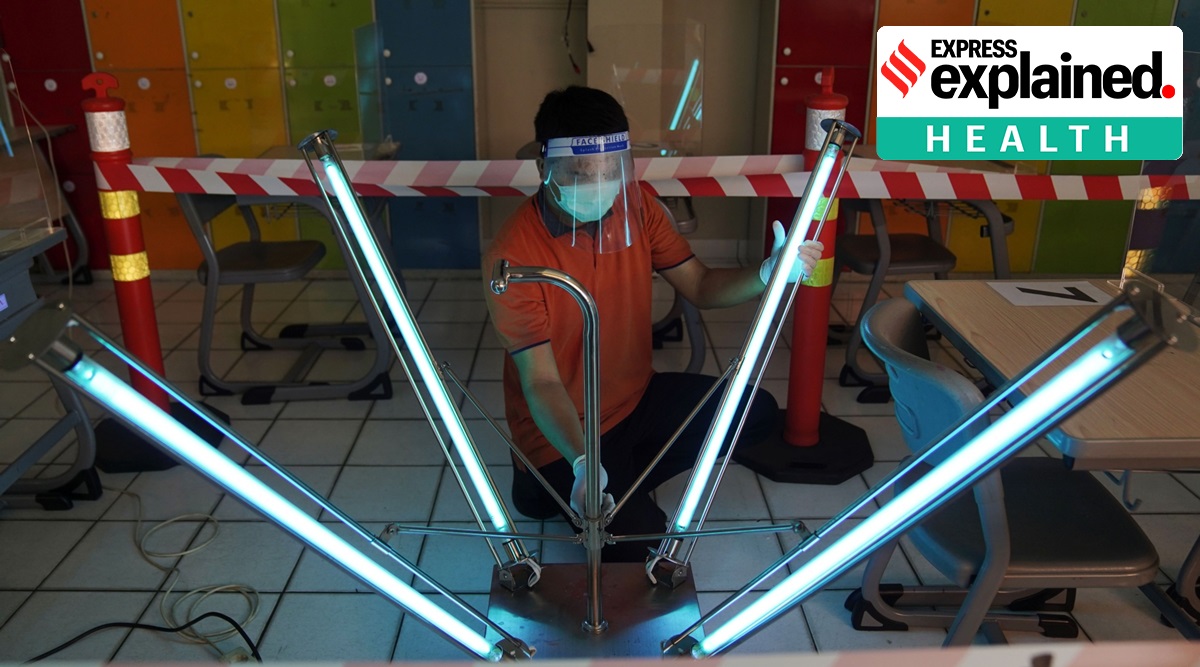 A maintenance worker wearing a protective mask and face shield uses ultraviolet light to sanitize a classroom at Nassa School in Bekasi, West Java, Indonesia. (Bloomberg Photo: Dimas Ardian, File)