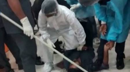 In the 55-second video, a paramedic is seen pinning the patient to the ground by placing his knee on his chest even as others hold his hand and security guards, one of them wielding a baton, look on.
