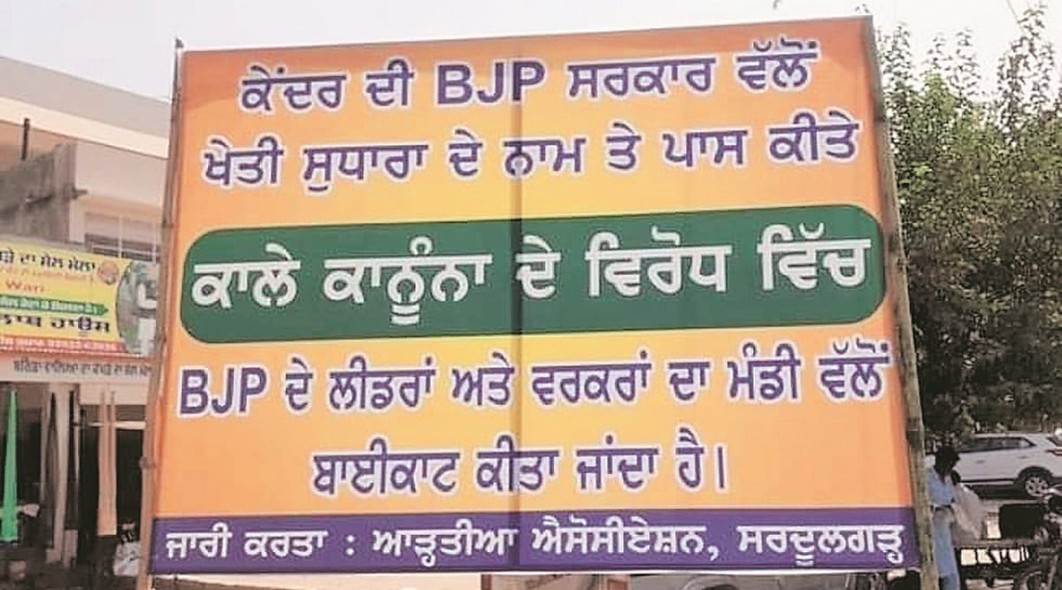 A board announcing boycott of BJP in Sardulgarh mandi of Mansa district on Tuesday. (Express Photo)