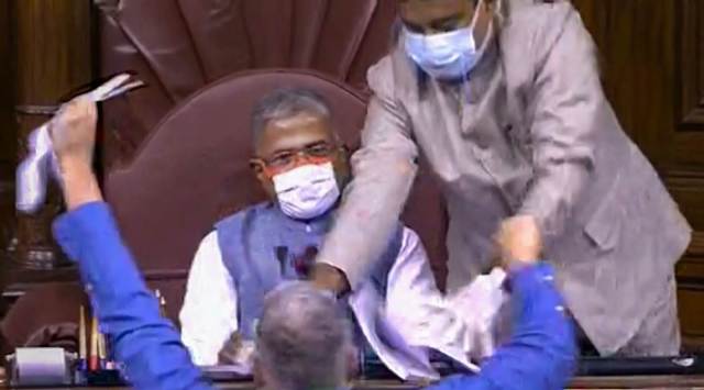 TMC MP Derek O'Brien attempts to tear the rule book as ruckus erupts in the Rajya Sabha over agriculture related bills, during the ongoing Monsoon Session, at Parliament House in New Delhi, Sunday. (Photo: Screengrab @ RSTV via PTI)