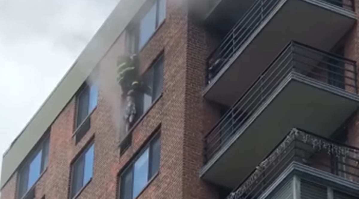 firefighter, firefighter saves woman, Manhattan building fire rescue. viral video, trending, indian express, indian express news