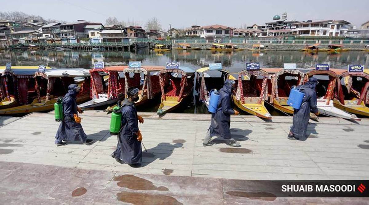 Health Workers sanitise the precinct of the Dal Lake in Srinagar, Kashmir after rising numbers of Covid 19 cases. The otherwise serene tourist sport was bereft of life for months on end. (Express Photograph by Suhaib Masoodi)