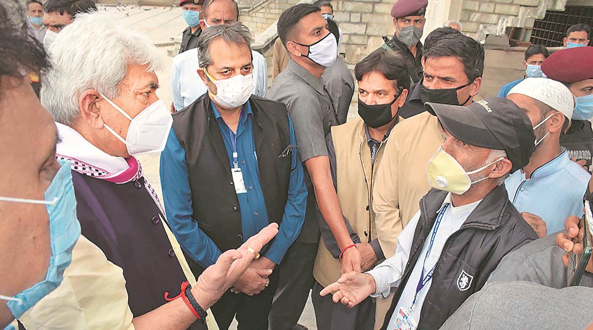 Jammu and Kashmir Lt Governor Manoj Sinha speaks with local residents during his visit to the Charar-i-Sharief shrine in Budgam district on Thursday. (PTI)