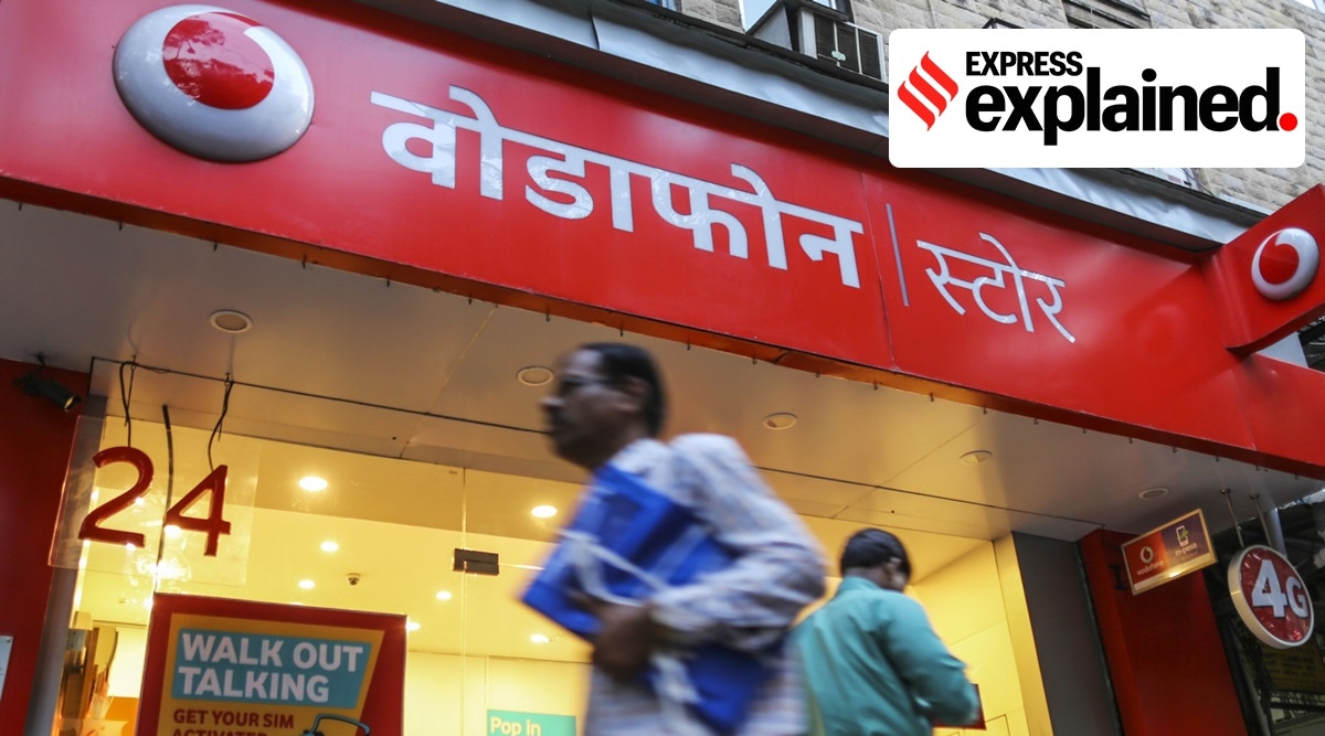 Pedestrians walk past a Vodafone India Ltd. store in Mumbai. (Bloomberg Photo: Dhiraj Singh)