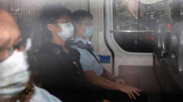 Former convenor of pro-independence group Studentlocalism, Tony Chung Hon-lam arrives at West Kowloon Magistrates‘ Courts in a police van after he was arrested under the national security law, in Hong Kong, China October 15, 2020. REUTERS/Tyrone Siu